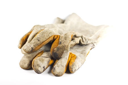 Dirty old leather gloves isolated on white backgroundの写真素材