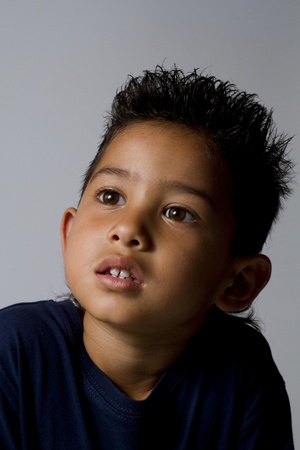 Little boy portrait on gray backgroundの写真素材