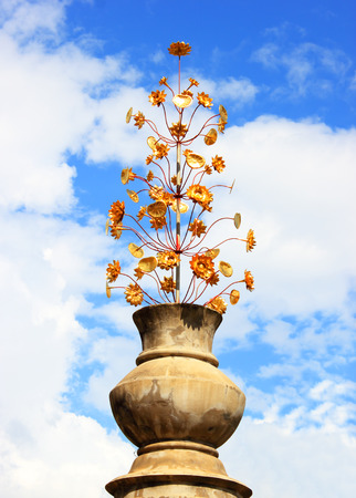 Old flowerpot with ornament and golden flower の写真素材