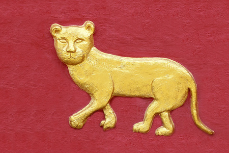 Golden Tiger sculptures on the wallの写真素材