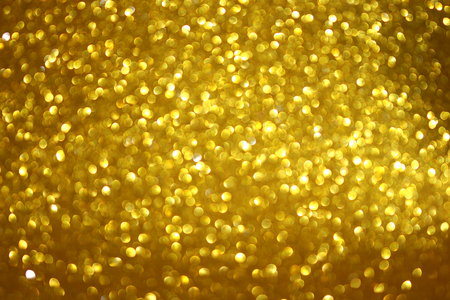 gold abstract bokeh glitter texture backgroundの写真素材