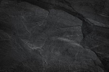 Dark grey black slate background or natural black stone texture. pattern of stone wall and floorの写真素材
