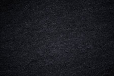 Dark grey black slate background or natural stone texture. Black stone wall.の写真素材