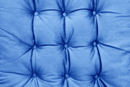 Blue velvet couch background texture with sunken buttonsの写真素材