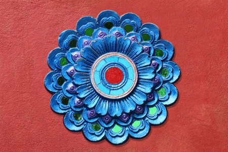 Pattern of stucco flower on red wall background. Traditional style flower pattern decorative