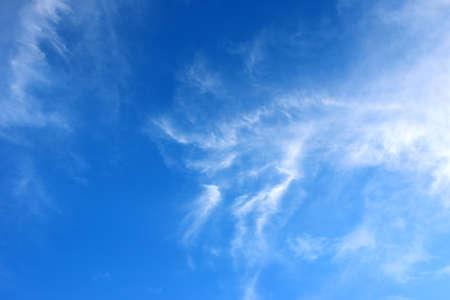 Blue sky background and white clouds soft focus, bright blue background.の写真素材