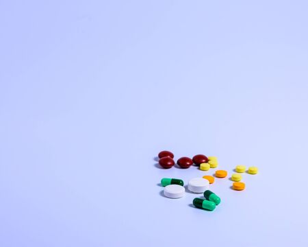 The medicine is out of the bottle on a white table.の写真素材