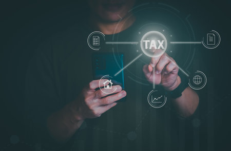 financial research government tax and calculation tax return concept Businessman showing holographic tax on hand Online tax return form filling concept for payment, online marketing, business process.の写真素材