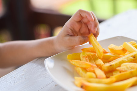 child eating french fries or potato chips.の写真素材