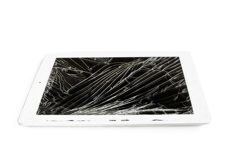 tablet computer with broken glass screen isolated on white backgroundの写真素材