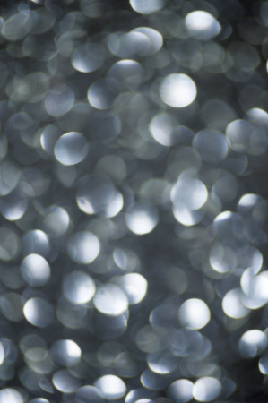 defocused abstract black silver lights backgroundの写真素材