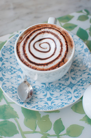 a cup of coffee with milk and chocolateの写真素材