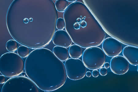 blue oil drops on a water surface abstract backgroundの写真素材