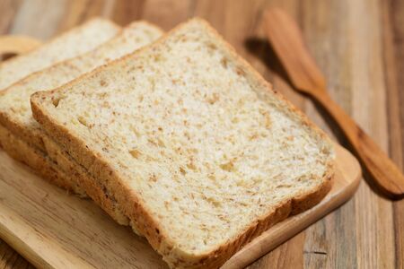 closeup of slices bread on wooden tableの写真素材