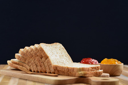 slices bread with fruit jam on wooden tableの写真素材