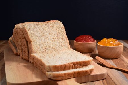 slices bread with fruit jam on wooden tableの写真素材
