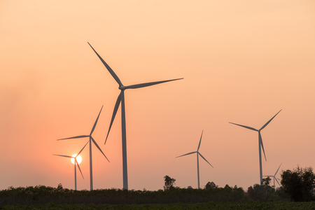 silhouette of wind turbines power generator at sunsetの写真素材