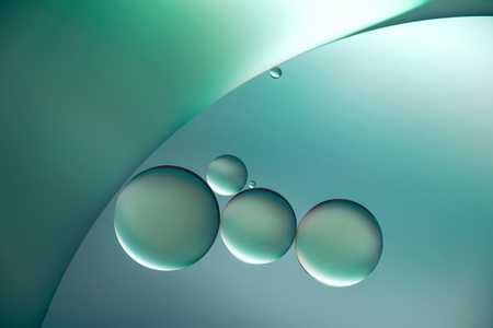 blue oil drops on a water surface abstract background