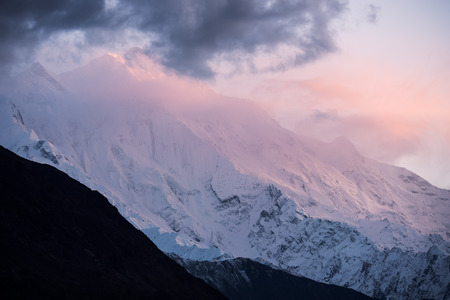 Sunset in the Rakaposhi mountains peak in the Karakoram mountain range in Northern Pakistan (Altitude: 7,788 meters)の写真素材
