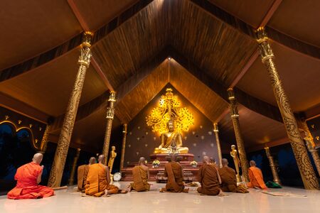 UBON RATCHATHANI, THAILAND - February 18, 2019: Group of buddhist monks are chant at night before Makha Bucha Day at Wat Phu prao or Sirindhorn Wararam Phu Prao Temple or called glow temple on February 18, 2019, Sirindhorn district, Ubon Ratchathani, Thaiのeditorial素材