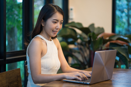 Portrait of Young Asian woman working with laptop on the table, business conceptの写真素材