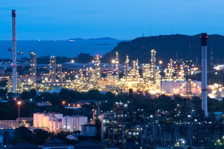 pipelines and towers of oil and gas refinery petrochemical factory at night, petroleum and chemical plantの写真素材