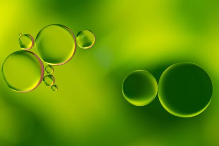 Green oil bubbles on a water surface abstract