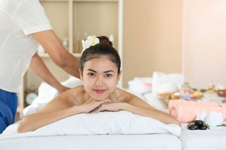 Young Asian woman getting massage in the spa salon, enjoying and relaxing, Healthy conceptの写真素材