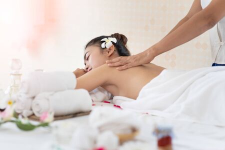 Young Asian woman getting massage in the spa salon, enjoying and relaxing, Healthy conceptの写真素材