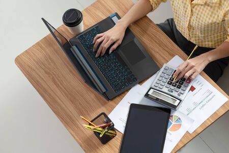 Close up of a businesswoman hands typing in a laptop at her house, work from home, business conceptの写真素材