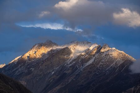 Sunset at the mountains peak in the Karakoram mountain range view from Hunza viewpoint, Gilgit Baltistan, Northern Pakistanの写真素材