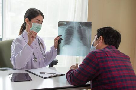 Young Asian Female Doctor explaining lung x-ray to patient, Healthcare and Medical concept