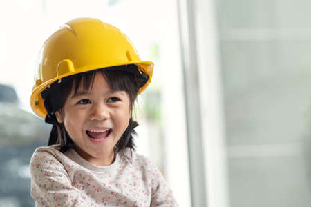 Young Asian child engineer wearing helmet, education and occupation conceptの写真素材