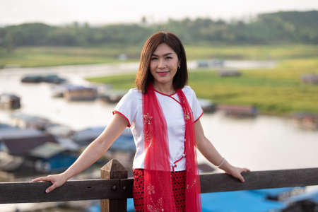 Young asian women traveler get dress traditional costume of Mon tribal at Mon village, Sangkhlaburi, Kanchanaburi, Thailand, traveling and Journey trip conceptの写真素材