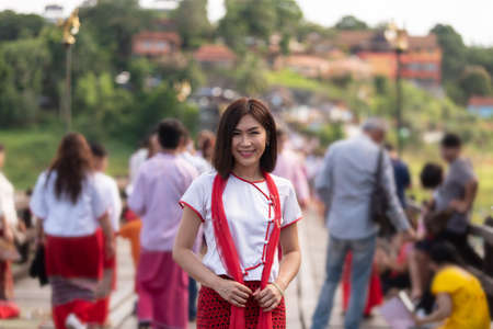 Young asian women traveler get dress traditional costume of Mon tribal at Mon village, Sangkhlaburi, Kanchanaburi, Thailand, traveling and Journey trip conceptの写真素材