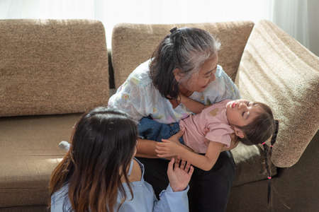 Happy Asian family having fun in their house, love and happiness people concept with homeの写真素材