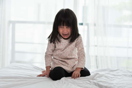 Portrait of Asian little girl sad and cryingの写真素材