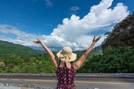 Young Asian women traveler with mountain behind the scenesの写真素材