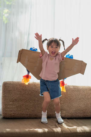 Portrait of happy Asian little child girl playing in an astronaut costume