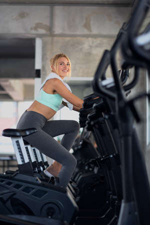 Portrait of young women exercising on cardio machines in the gym