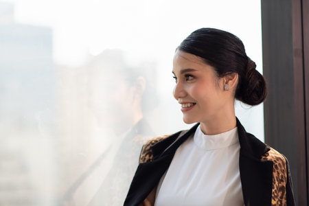 Portrait of businesswoman working in the office with looking out of the windowの写真素材