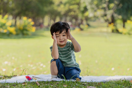Happy Asian little child having fun playing in the parkの写真素材