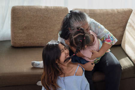 Happy Asian family having fun in their house, love and happiness people concept with homeの写真素材