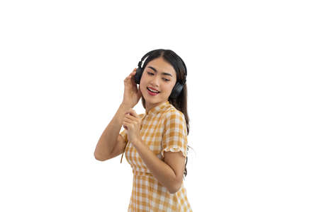 Portrait of Young Asian woman enjoy listening to music with headphones