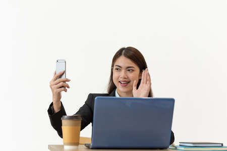 Young Asian businesswoman taking selfie with mobile phoneの写真素材