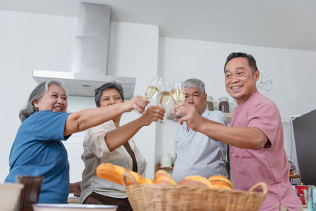 Group of Happy Asian senior dining together drinking wine to celebrate