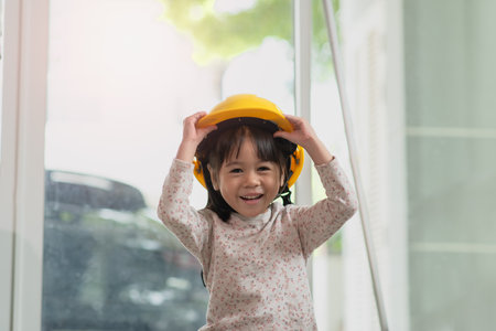 Young Asian child engineer wearing helmet, education and occupation conceptの写真素材