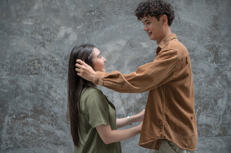 Asian young couple looking each other and hugging, male and female spending time together