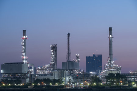 pipelines and towers of oil and gas refinery petrochemical factory at night, petroleum and chemical...