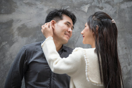 Asian young couple looking each other, male and female spending time together